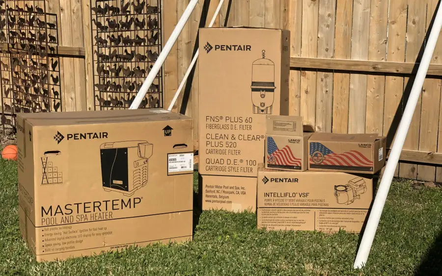Boxed Pentair MasterTemp pool heater, cartridge filters and IntelliFlo variable-speed pump ready for installation